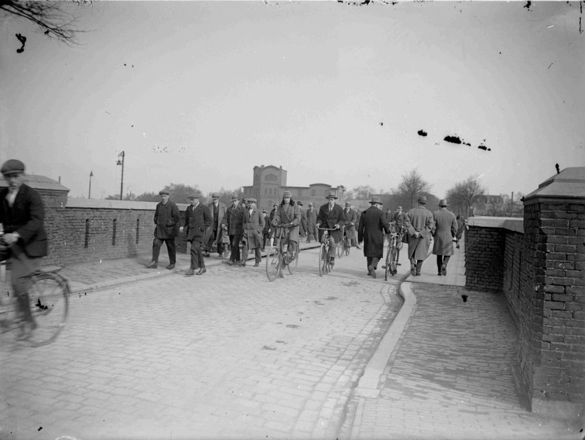 Een drukte van belang op het smalle viaduct over de spoorlijnen Nijmegen Venlo en Nijmegen Den Bosch met op de achtergrond het tabakspakhuis van de TURMAC, 1910-1930 (GN11116 RAN)