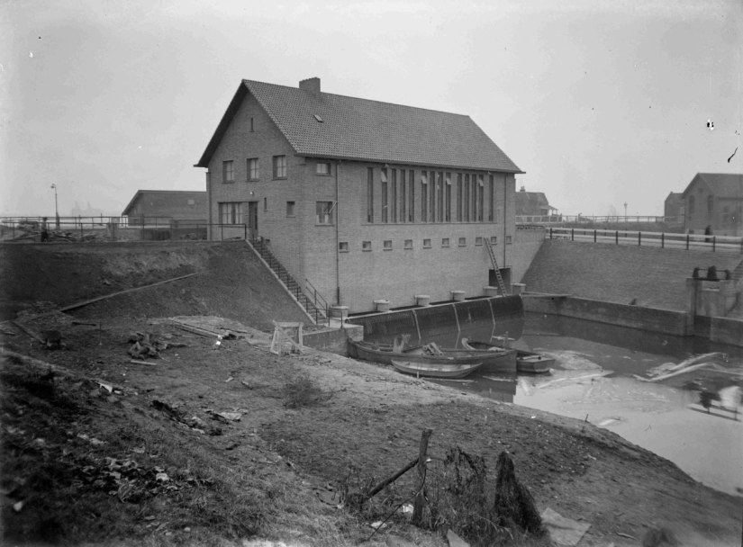 Op 23 januari 1934 werd na een eeuwenlange strijd over de afwatering van de Duffelt het Hollands-Duits gemaal in werking gesteld. De foto toont de achterzijde van het gemaal, Ooysedijk, Ooijsche Schependom, 1938 (GN10858 RAN)