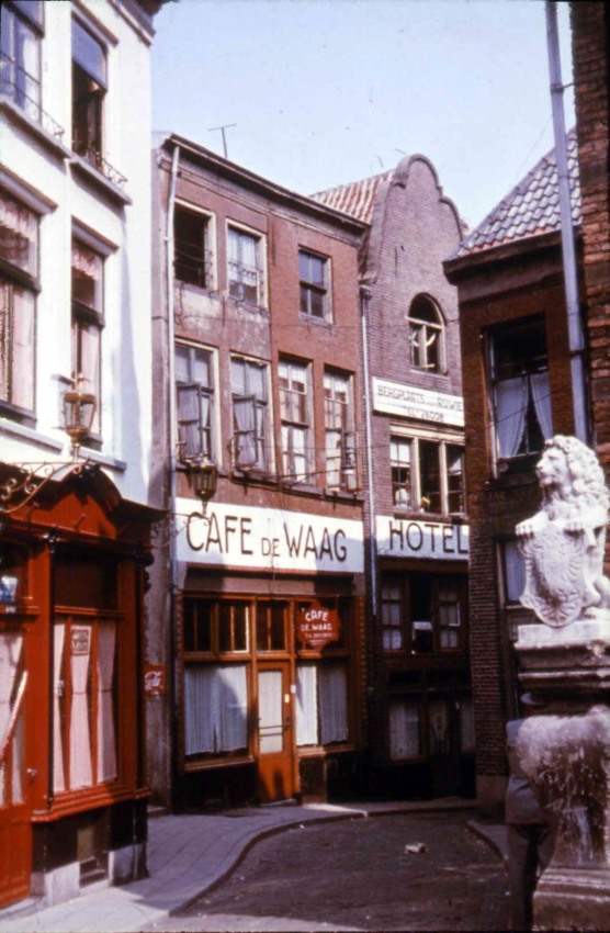 Achter de Hoofdwacht, gezien vanaf de Grote Markt in de richting van Kannenmarkt en de Korenmarkt. Links het huidige In de Blaauwe Hand, rechts de trappen van het Waaggebouw. Het laatste pand links heeft een gerestaureerde klokgevel, 1930-9/1944 (D2 RAN)